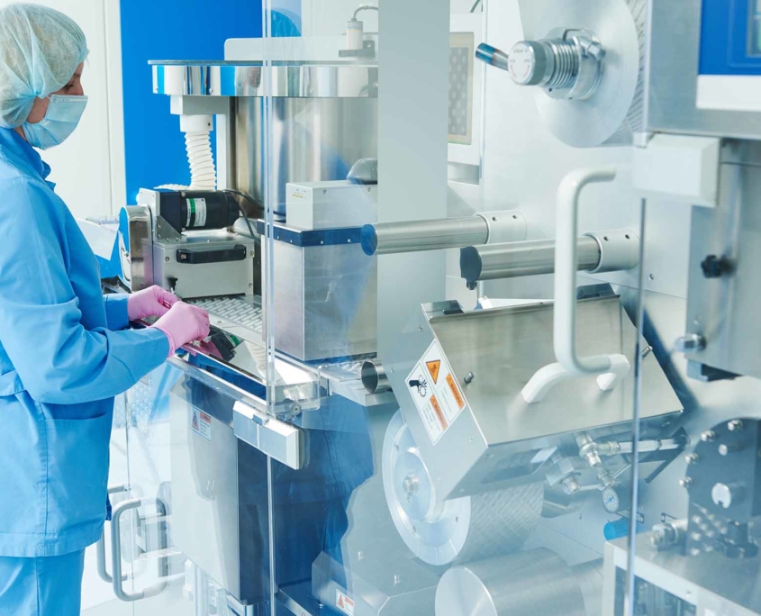 pharmacy operator working with a blistering machine