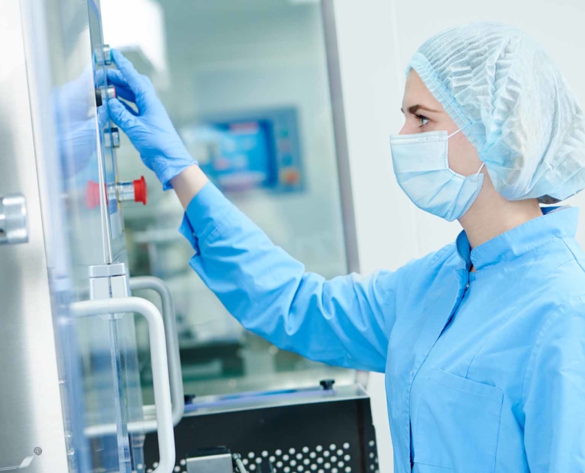 pharmacy worker operating a large piece of machinery