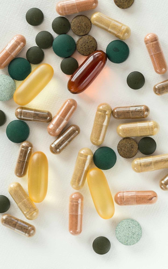 Nutraceutical Packaging and pills on top of a table vertical
