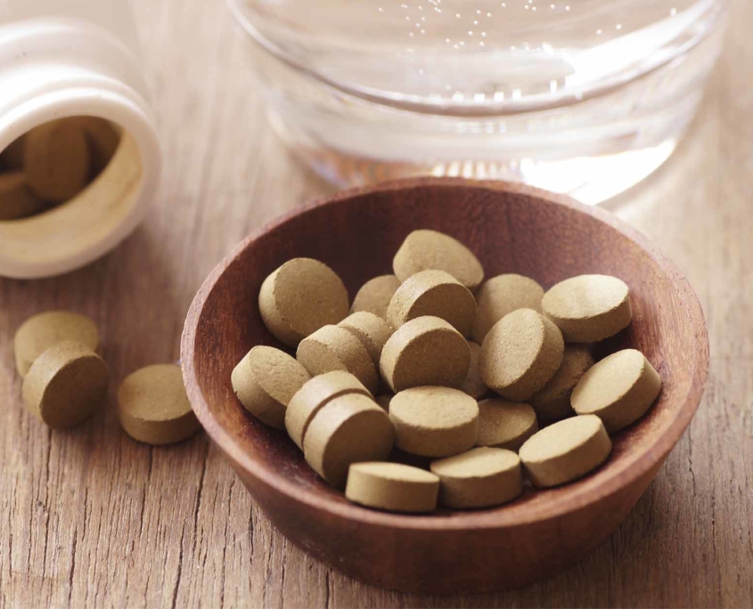 Pressed cannabis pills sitting in a little bowl