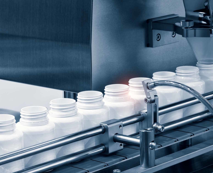 pharmaceutical industry, medicine pills are filling in the bottle on production line machine conveyor at the medical factory selective focus