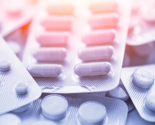 Different medicines_ tablets, pills in blister pack, medications drugs, macro, selective focus, copy space, blue toned