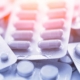 Different medicines_ tablets, pills in blister pack, medications drugs, macro, selective focus, copy space, blue toned