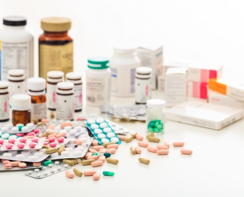 Variety of different medications packaged on a table.