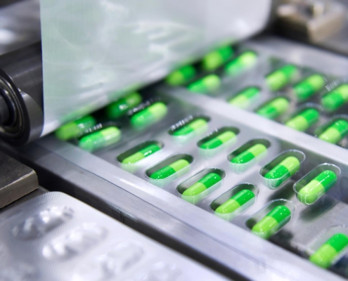 Medication being put into blister packaging by machine