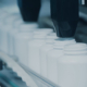 Side view of bottle filling conveyor for medicine